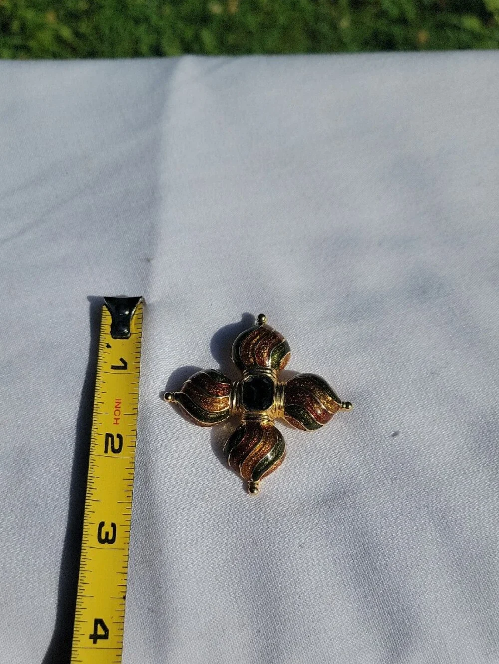 Vintage Joan Rivers Gold-Tone Cross Brooch with Green Center & Amber Enamel